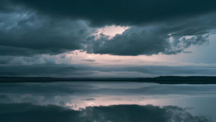 Obraz premium Dramatic Storm Clouds and Lightning Reflected on Calm Wilderness Lake Landscape