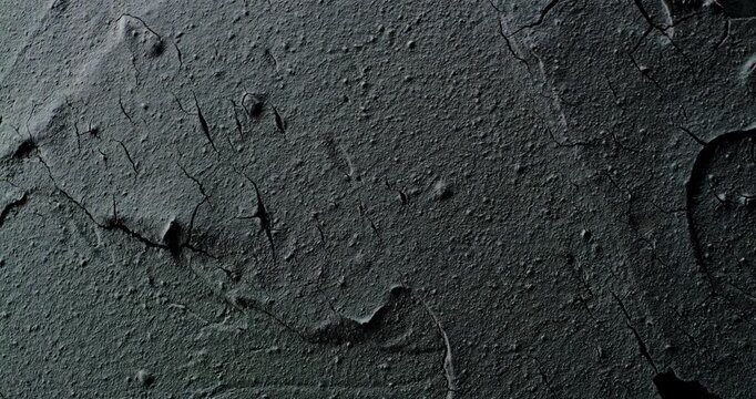 Cracked texture slow rotation. Close-up of rough surface with thick cracked layers and peeling flakes. Smooth continuous rotation reveals evolving light reflections.