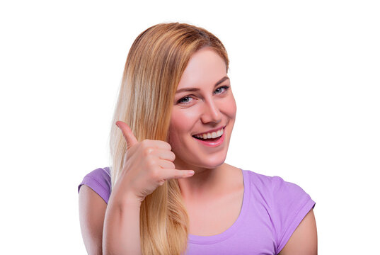 A cheerful blonde woman smiling and making a call-me hand gesture against a white background.