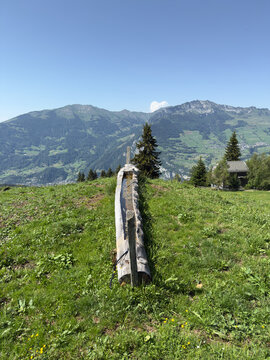 Weathered Wooden Cross on a Lush Alpine Meadow With Valley and Mountain Panorama in Switzerland