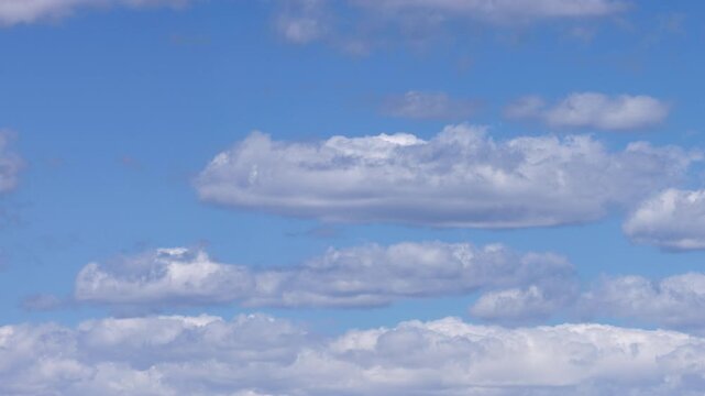Moving White Clouds Across Brilliant Blue Sky Timelapse Background