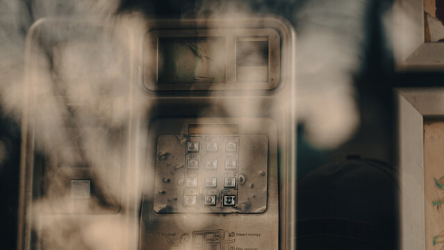 an old telephone in a telephone booth