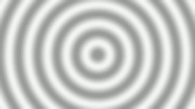 Concentric circles of light and shadow create a hypnotic ripple effect.