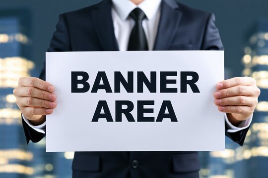 Businessman holding a sign with the words banner area