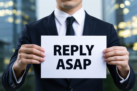 Professional businessman holding a sign with reply asap concept