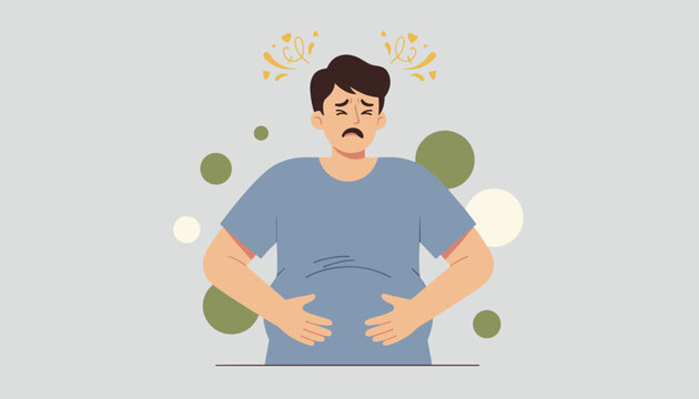 Young man suffering from stomach pain, bloating, or indigestion holding his belly with a worried expression.