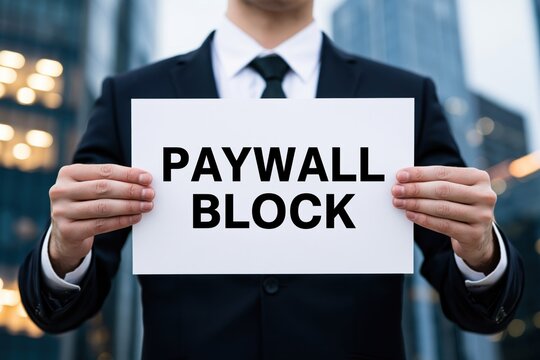 Corporate businessman holding a white paper document with the text paywall block