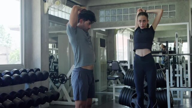 Dynamic workout session a fitness trainer guiding a client through jump exercises in a modern gym setting