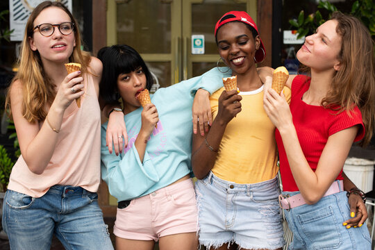 Friends enjoying ice cream outdoors.