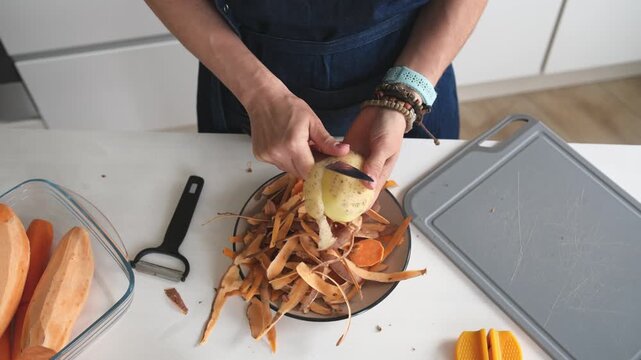 Woman Cleaning Potatoes Close-Up Top View