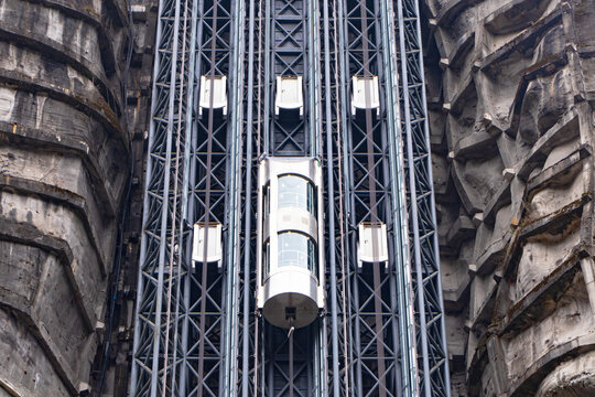 Structure glass capsule elevator mounted on steep mountain cliff, showcasing advanced engineering breathtaking vertical transportation. Modern scenic lift offers dramatic of rugged rock formations.
