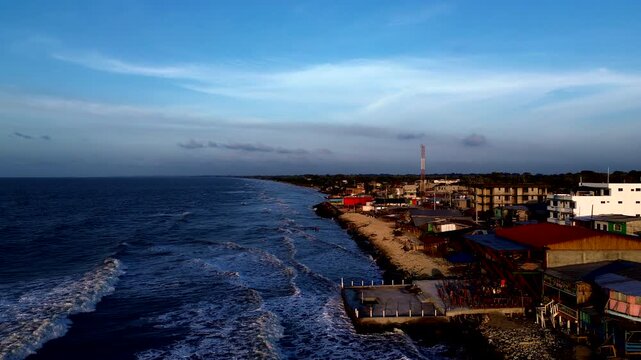 Aerial View of Tropical Ecuador Coastline at Dusk, Ocean Waves, Beachfront Town, Blue Sky and Scenic South American Seascape Travel Background