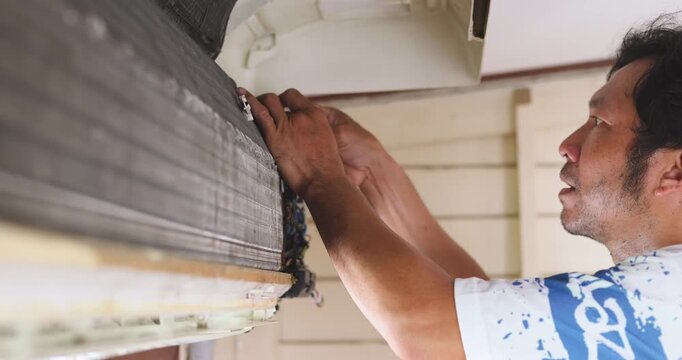 Mechanic man repair and clean air condition in city home diagnostic electronic industry