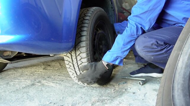 Bila Tserkva, Ukraine, April 27, 2025: A Mechanic Attends to a Vehicle Tire Change, Ensuring Safety and Efficiency in Replacing the Tire on a Vehicle's Wheel