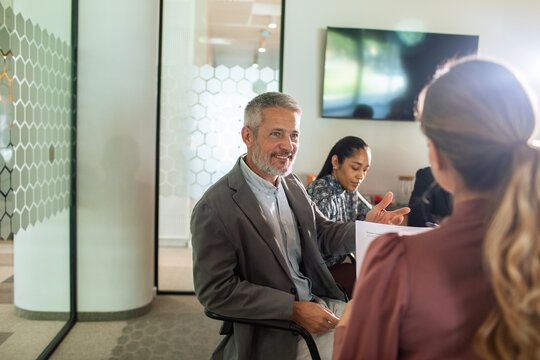 Mature manager interviewing candidate in modern office