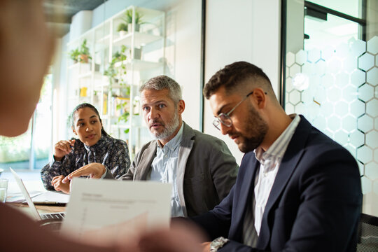 Diverse business team discussing strategy in modern office