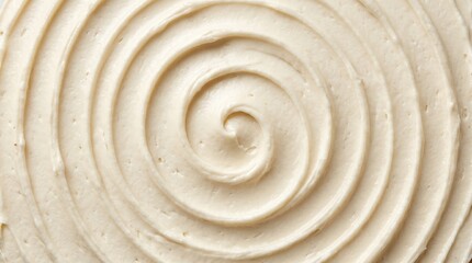 Fototapeta premium Close up concentric swirl of vanilla buttercream frosting with smooth ridges and creamy texture on neutral surface, food detail and pattern study