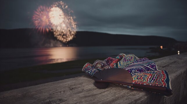 yukata. Folded fan and yukata sleeve on doorstep with fireworks over Sumida River, Tokyo summer celebration. event programs, museum guides, designed for cultural heritage projects and event programs.
