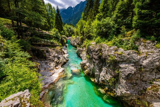 Soča or Isonzo River called Emerald River in Slovenia is a wild alpine river with crystal clear water and typical turquoise green color with many rapids, waterfalls, basins and pools in narrow canyon