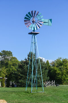 Old metal windmill under sky