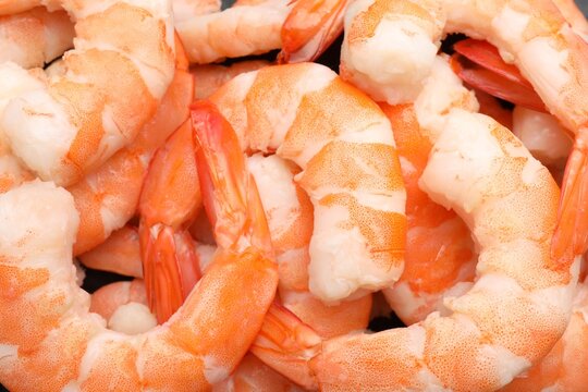 Many boiled shrimps on dark table, top view