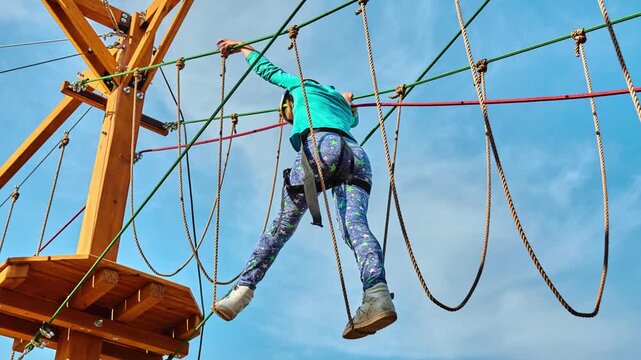 Girl climbing in adventure park