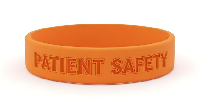 An orange (awareness color) wristband with "Patient Safety" engraved on it, on white.