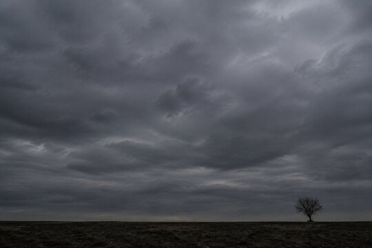 Heavy, overcast sky at dusk with thick gray clouds blocking the sun.