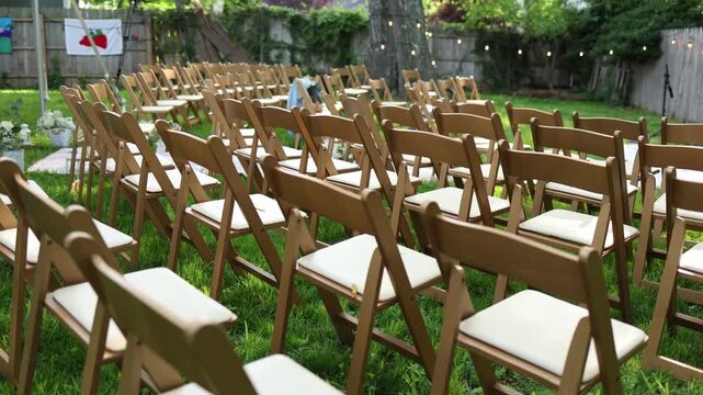 Outdoor wedding chairs arranged on backyard lawn