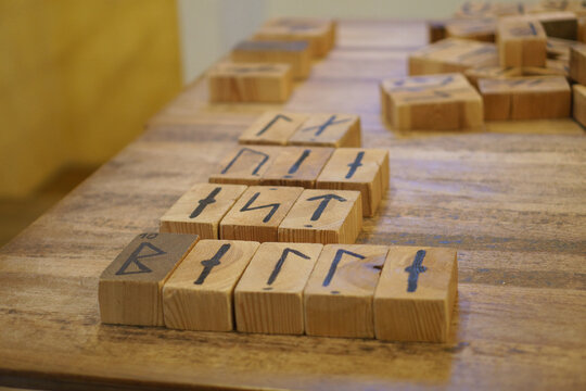 Mystic wooden rune stones on a rustic wooden table