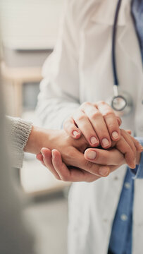 Compassionate doctor comforting patient during consultation