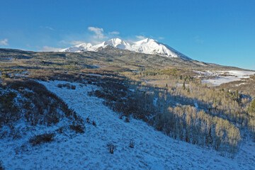 Obraz premium Aerial view of Mount Sopris and surrounding forest near Carbondale in Pitkin County, Colorado after light spring snowfall.