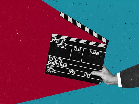 Hand holding a film clapboard on a red and blue artistic background