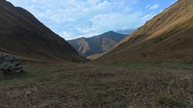 4k video of a hiker walking forward through a scenic mountain valley from Juta to Roshka, Georgia.