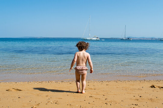 Toddler Sitting on a Sandy Adriatic Beach, Enjoying Summer by the Sea in Croatia