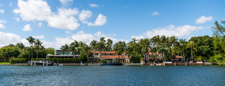 Vacation building in summertime. Luxury waterfront house. Hotel building. Residential architecture. Modern building Miami. Residential apartment in waterfront city. Waterfront landscape with house