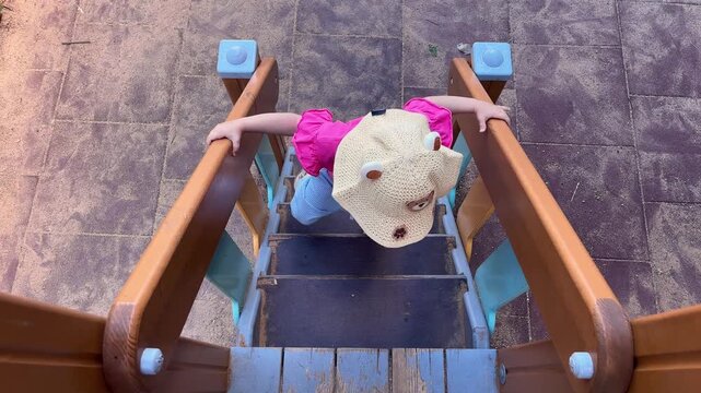 Child walking down playground stairs developing motor skills