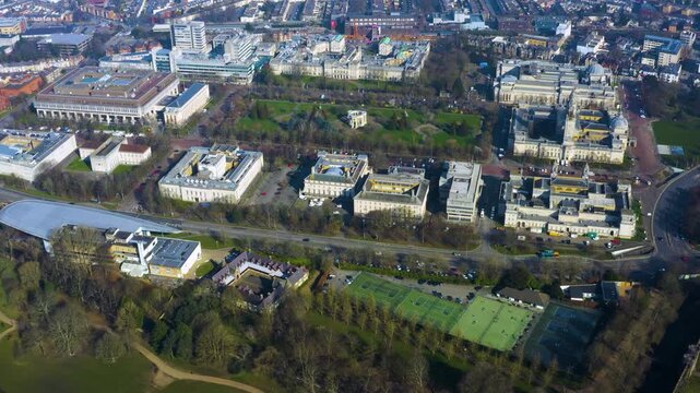 Aerial drone view of Cathays Park, Cardiff, Wales, showing Cardiff University buildings, Bute Park, civic architecture, tennis courts, and the River Taff in winter daylight.