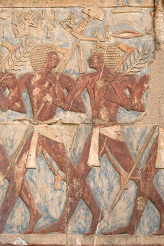 Ancient Egyptian art and inscriptions depicting the daily life and ceremonies of the Pharaoh kings at the historical Temple of Hatshepsut, Deir el-Bahari, Luxor, Egypt.