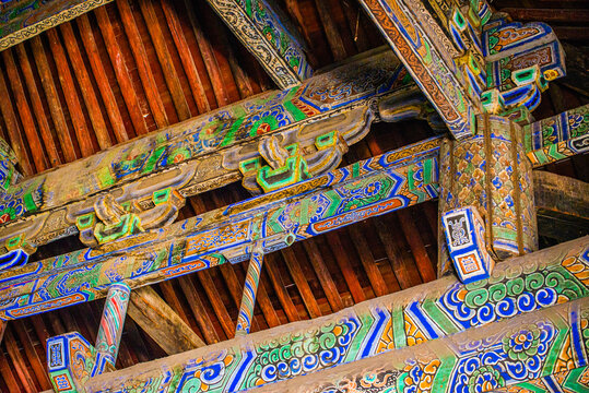 Datong, China - May 9 2026: Elaborate dougong structure in Sanhua Temple demonstrates sophisticated interlocking wooden brackets supporting layered roofs with refined ancient Chinese architecture