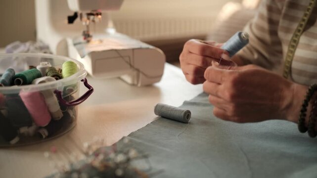 Seamstress Matches Thread To Fabric Color With Hands Up Close