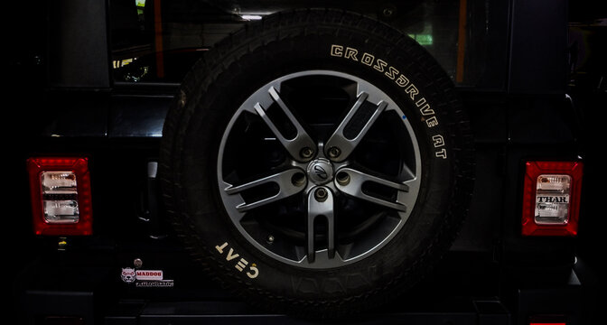 Thar Roxx car rear side with stepney tyre. Mahindra Thar Roxx is a rugged SUV. Available in various colors.  Mahindra and Mahindra (M&M) is an Indian automobile manufacturing company.