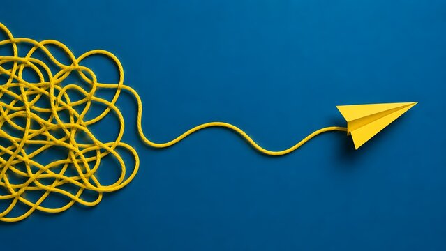 Simplifying complexity and problem solving concept with tangled yellow rope becoming a straight path to a paper airplane