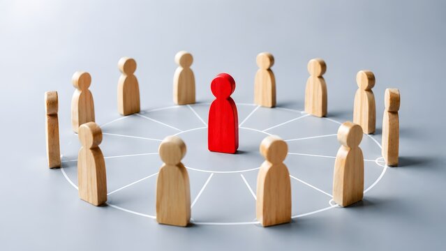 Standing out from the crowd and leadership concept featuring a red wooden figure centered among a circle of wooden people