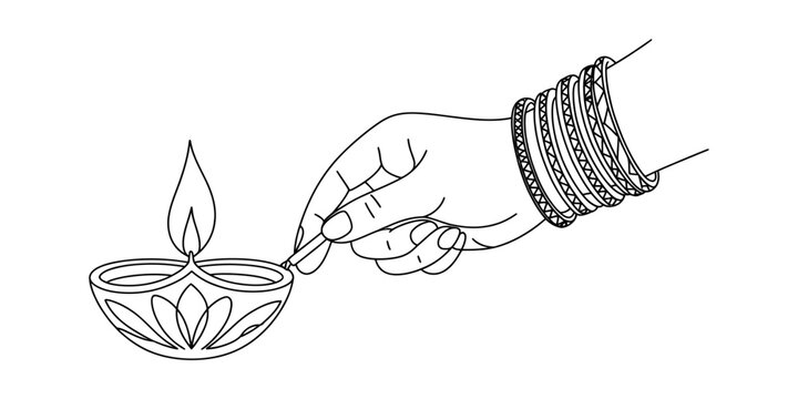 Woman hand lighting a traditional clay diya oil lamp for diwali festival celebration