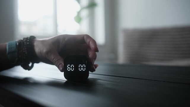 Girl Sets A Tabletop Electronic Timer With Hand To Focus On Work