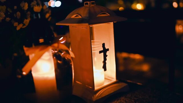Candles On Grave In Cemetery On All Saints' Day