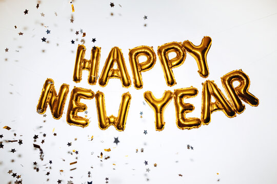 Gold happy new year balloons with confetti