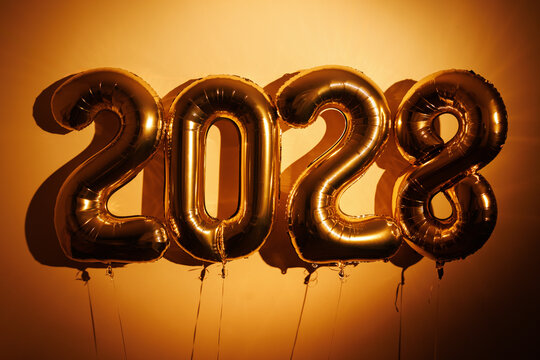 Gold foil balloons forming new year 2028 numbers