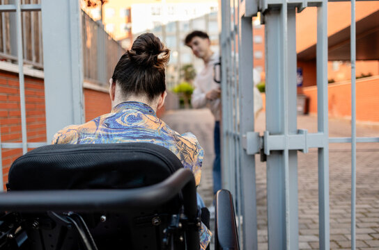 Navigating accessibility with open gate looking at friend